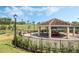 Picturesque gazebo with a tiled roof, set in a beautifully landscaped area, perfect for relaxation and social gatherings at 3525 Belland Cir # A, Clermont, FL 34711