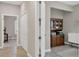 Hallway leading to the office and bedroom features neutral paint and tile floors at 3525 Belland Cir # A, Clermont, FL 34711