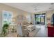 Bright living room featuring tile floors, a ceiling fan, neutral paint, and sliding glass doors to the patio at 3525 Belland Cir # A, Clermont, FL 34711