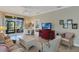 Bright living room features neutral colors, tile floors, and sliding glass doors to the patio at 3525 Belland Cir # A, Clermont, FL 34711