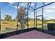 Enclosed patio featuring a brick floor and views of the beautiful green backyard at 3525 Belland Cir # A, Clermont, FL 34711