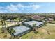 Aerial shot of tennis courts and bocce ball, surrounded by lush landscaping and mature trees, perfect for an active lifestyle at 3525 Belland Cir # A, Clermont, FL 34711