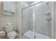 Bathroom featuring a glass-door shower, a tiled shower with a shower head and built-in shelving at 3541 Belland Cir # A, Clermont, FL 34711