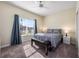 Bedroom with a ceiling fan, carpet, a large window with curtains, and a bench at the end of the bed at 3541 Belland Cir # A, Clermont, FL 34711