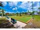 Outdoor bocce ball court featuring a pair of courts with artificial turf, benches and lighting at 3541 Belland Cir # A, Clermont, FL 34711