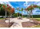 Community park featuring flowers, palm trees, a monument, and flags near outdoor tennis courts at 3541 Belland Cir # A, Clermont, FL 34711