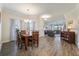 Open-concept dining room with a wooden table and a view of the cozy living area at 3541 Belland Cir # A, Clermont, FL 34711