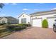 Charming single-story home featuring a well-maintained lawn and a two-car garage with a brick-paved driveway at 3541 Belland Cir # A, Clermont, FL 34711