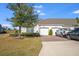 Charming home featuring a two-car garage, well-maintained lawn, mature tree, and lovely landscaping at 3541 Belland Cir # A, Clermont, FL 34711