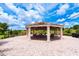 Covered outdoor gazebo with a red tile roof over a paver patio featuring chairs and outdoor lighting at 3541 Belland Cir # A, Clermont, FL 34711