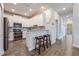 Modern kitchen featuring sleek white cabinets and a convenient breakfast bar with seating at 3541 Belland Cir # A, Clermont, FL 34711