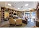 Cozy library featuring comfortable seating, a fireplace, built-in bookshelves, and natural light at 3541 Belland Cir # A, Clermont, FL 34711