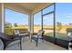 Screened-in lanai with wicker furniture, offering a relaxing outdoor space with beautiful views of the open backyard at 3541 Belland Cir # A, Clermont, FL 34711