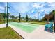 Outdoor shuffleboard courts in a landscaped area featuring shaded seating and bright overhead lighting at 3541 Belland Cir # A, Clermont, FL 34711