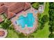 Aerial view of the community pool, featuring ample seating and a hot tub, surrounded by greenery at 3541 Belland Cir # A, Clermont, FL 34711