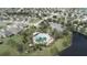 Aerial view of the community showcasing a resort-style pool, lush landscaping, and well-maintained homes at 3610 Charmed Ln, St Cloud, FL 34772