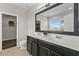 Bathroom with a double vanity, modern fixtures, and a view into the walk-in closet at 3610 Charmed Ln, St Cloud, FL 34772