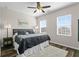 Comfortable bedroom with wood floors, ceiling fan and large windows providing natural light at 3610 Charmed Ln, St Cloud, FL 34772
