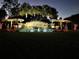 Festive community entrance sign with lighted snowmen and palm trees at dusk at 3610 Charmed Ln, St Cloud, FL 34772