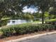 Scenic view of community pond surrounded by lush landscaping and mature trees, perfect for a relaxing stroll at 3610 Charmed Ln, St Cloud, FL 34772