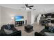Open-concept living room with tile flooring, connected to the kitchen with stainless appliances at 3610 Charmed Ln, St Cloud, FL 34772