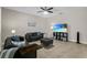 Cozy living room features two gray sofas, ceiling fan, and a TV displaying beach scenery at 3610 Charmed Ln, St Cloud, FL 34772