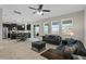 Spacious living room with tile flooring and a kitchen with modern, stainless steel appliances at 3610 Charmed Ln, St Cloud, FL 34772