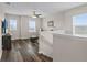 Loft area with wood flooring, a ceiling fan, and an open layout, perfect for a secondary living space at 3610 Charmed Ln, St Cloud, FL 34772