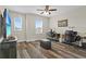 Upstairs loft featuring wood flooring, a ceiling fan and two desk spaces for a home office at 3610 Charmed Ln, St Cloud, FL 34772