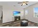 Loft area with wood flooring, a ceiling fan, and a mounted flatscreen TV for entertaining and relaxation at 3610 Charmed Ln, St Cloud, FL 34772