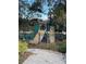 Community playground featuring a slide and climbing wall surrounded by lush landscaping at 3610 Charmed Ln, St Cloud, FL 34772