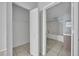Open bathroom and closet reveal light tile floors and shelving at 4004 Santa Maria Dr # 105, Kissimmee, FL 34741
