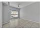 Bright bedroom features tiled floors, a ceiling fan, and a window offering natural light at 4004 Santa Maria Dr # 105, Kissimmee, FL 34741