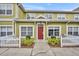 Inviting townhome with charming curb appeal, featuring a red front door and a well-maintained white picket fence at 4004 Santa Maria Dr # 105, Kissimmee, FL 34741