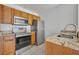 Well-appointed kitchen featuring stainless steel appliances, granite countertops, and ample cabinet space at 4004 Santa Maria Dr # 105, Kissimmee, FL 34741