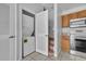 A laundry closet leads to stairs and a modern kitchen with stainless steel appliances at 4004 Santa Maria Dr # 105, Kissimmee, FL 34741