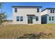 The home features a backyard with a well-maintained lawn and a sliding glass door at 4026 Copperleaf Ln, Poinciana, FL 34759