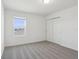 Cozy bedroom with plush gray carpeting, double door closet, and natural light from a window at 4026 Copperleaf Ln, Poinciana, FL 34759
