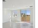 Spacious living room with tile flooring, a large window, and sliding glass doors to the backyard at 4026 Copperleaf Ln, Poinciana, FL 34759