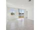 Bright room with serene lake views, large sliding glass doors, and neutral tile flooring at 4026 Copperleaf Ln, Poinciana, FL 34759