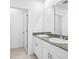 Bright bathroom features granite countertop, white cabinetry and double sinks at 4031 Cooperleaf Ln, Poinciana, FL 34759