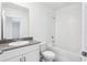 Pristine bathroom with a shower and tub, white cabinets, and granite counters at 4031 Cooperleaf Ln, Poinciana, FL 34759