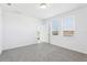 A bright bedroom is carpeted with neutral walls and has natural light from two windows at 4031 Cooperleaf Ln, Poinciana, FL 34759