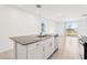 Open kitchen with granite island overlooks dining area and sliding glass doors to the backyard at 4031 Cooperleaf Ln, Poinciana, FL 34759
