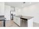 Bright kitchen featuring stainless steel appliances, granite countertops, and white cabinetry at 4031 Cooperleaf Ln, Poinciana, FL 34759