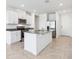 Modern kitchen featuring stainless steel appliances, granite countertops, and a center island at 4031 Cooperleaf Ln, Poinciana, FL 34759