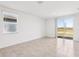 Bright living room with tile floors, large windows, and sliding doors to outdoor space at 4031 Cooperleaf Ln, Poinciana, FL 34759