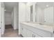 Bathroom featuring double sinks and bright mirrors at 4034 Copperleaf Ln, Poinciana, FL 34759