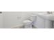Powder room featuring a white pedestal sink and toilet at 4034 Copperleaf Ln, Poinciana, FL 34759