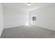 Well-lit bedroom with carpet, large window and white walls at 4034 Copperleaf Ln, Poinciana, FL 34759